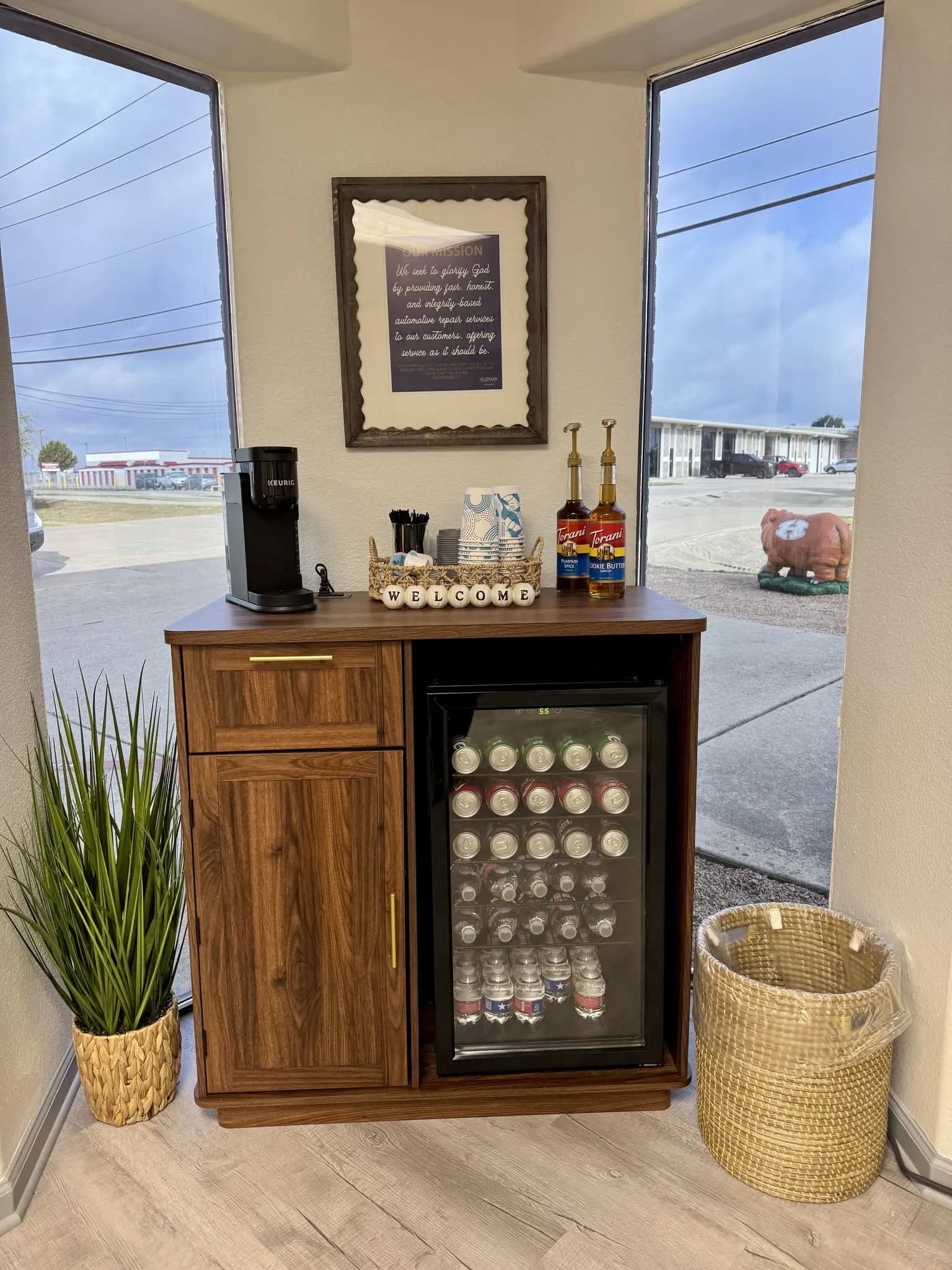 Complimentary coffee and cold drinks in the customer waiting area at Guzman Automotive in Hutto, TX