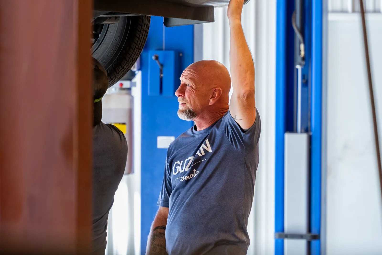 Guzman Automotive state inspector performing an emissions check