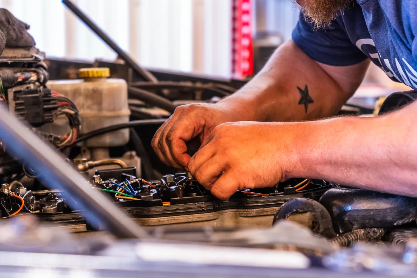 Guzman Automotive technician replacing vehicle shocks
