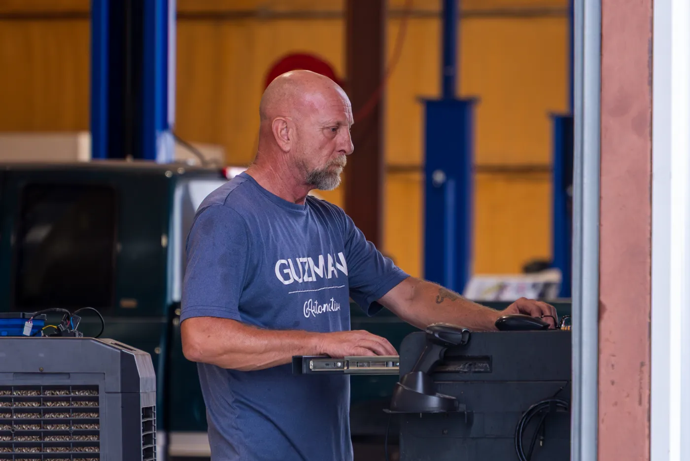 Guzman Automotive technician servicing a vehicle's steering system
