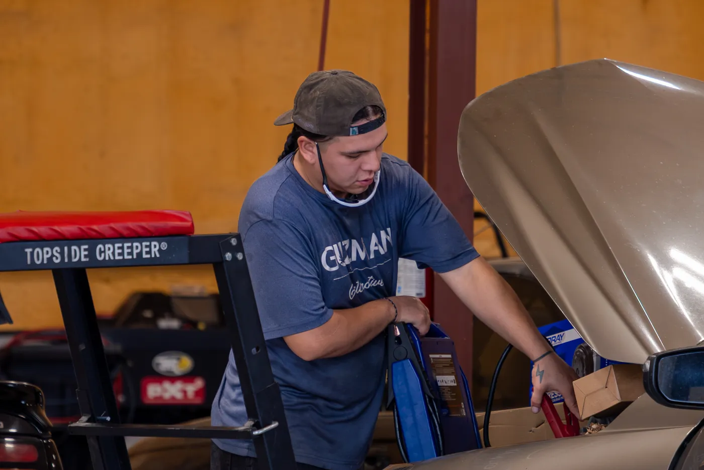 Guzman Automotive technician inspecting a vehicle's axles
