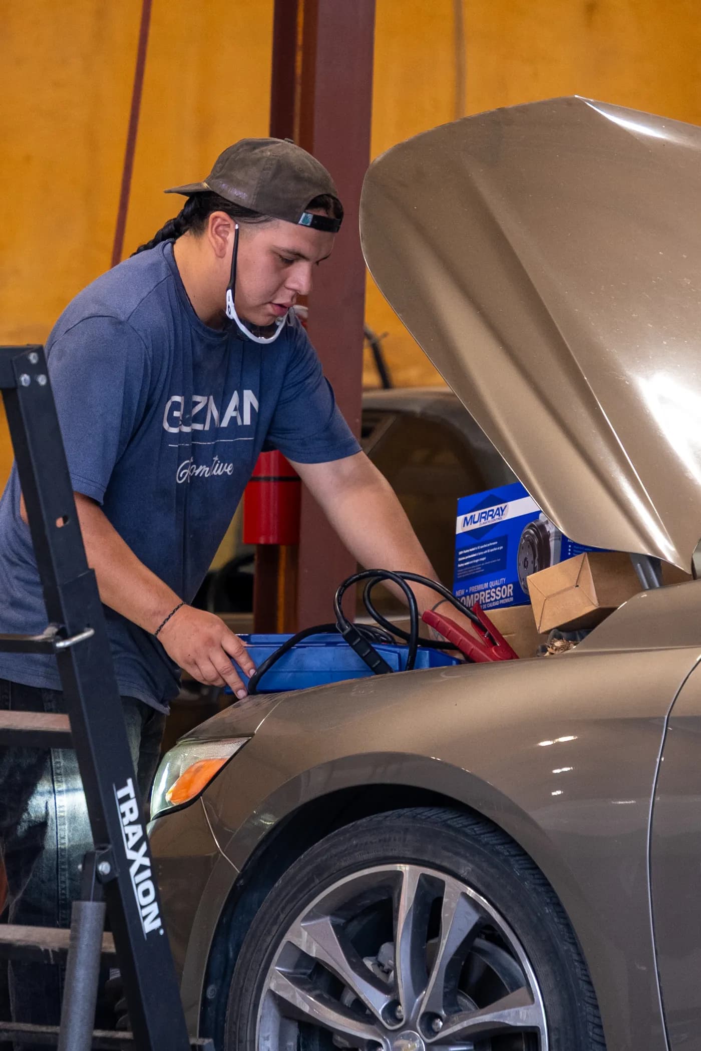 Guzman Automotive technician testing a vehicle battery