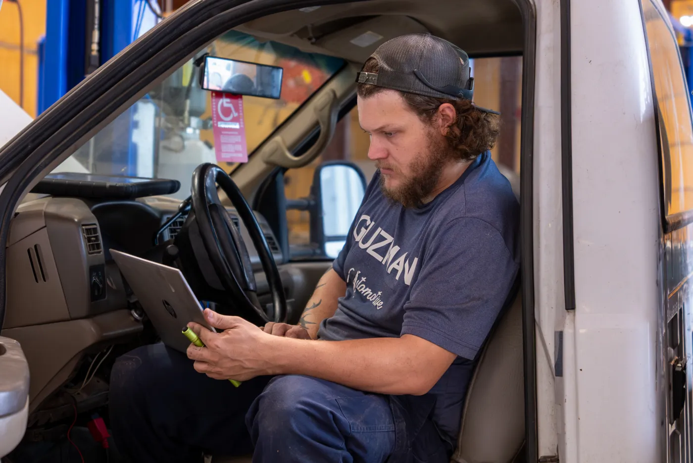 Guzman Automotive technician performing a vehicle tune-up