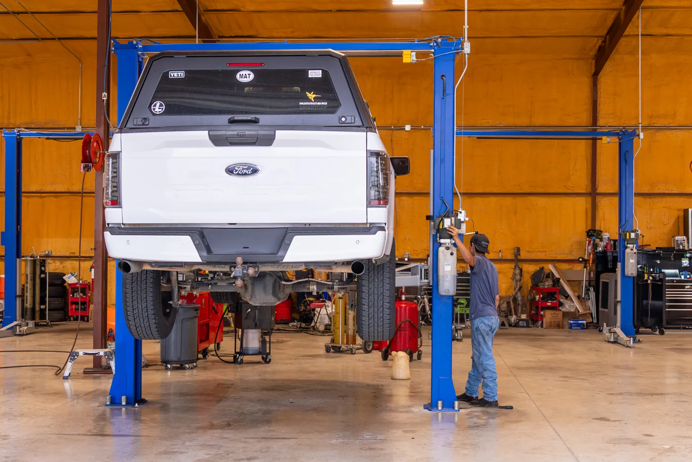 Guzman Automotive technician servicing a vehicle's cooling system