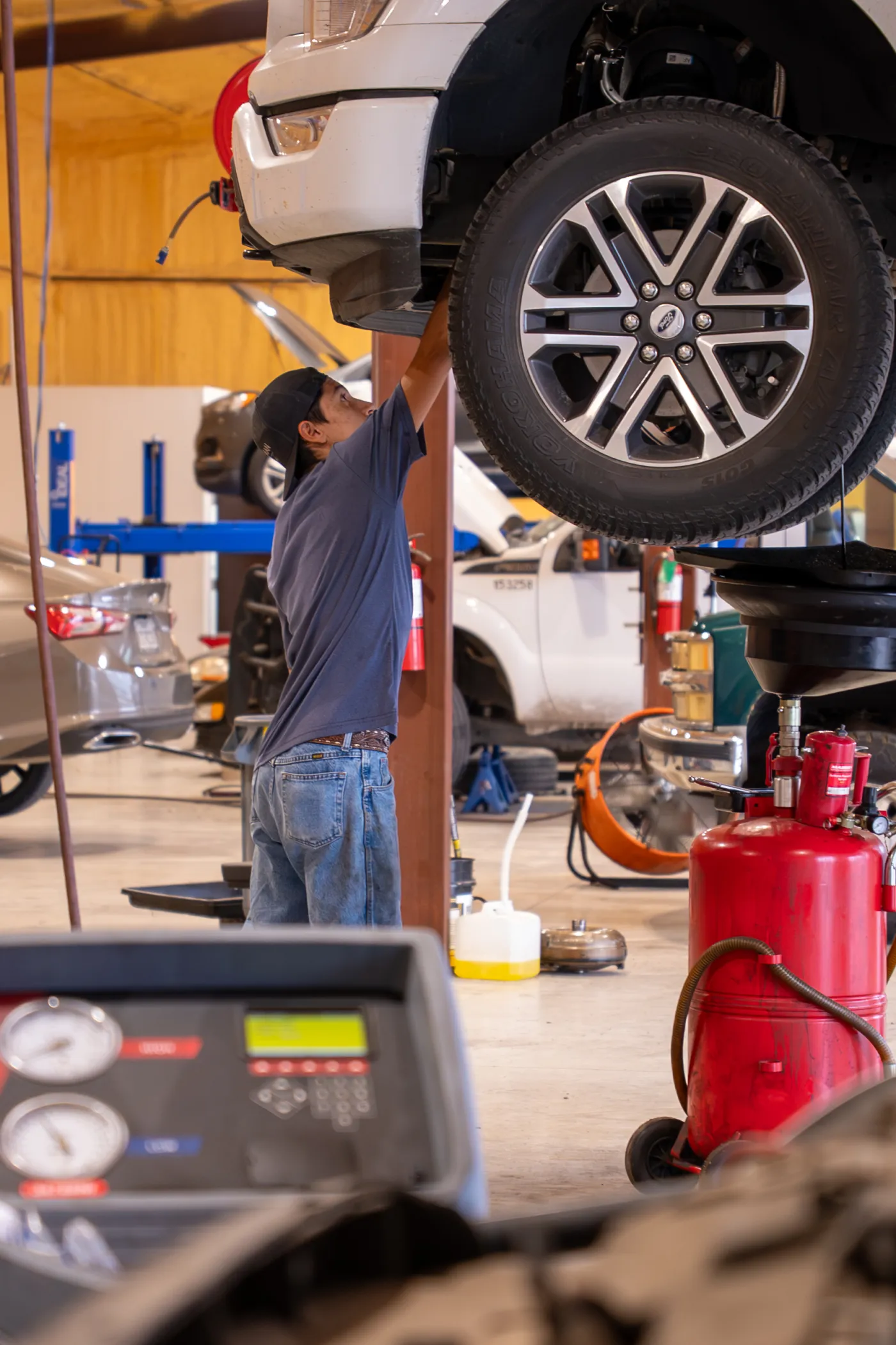 Guzman Automotive technician working on a vehicle's electrical system