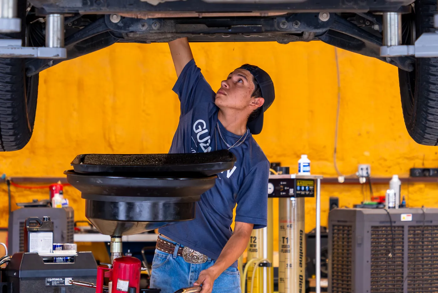 Guzman Automotive technician servicing a vehicle's fuel system