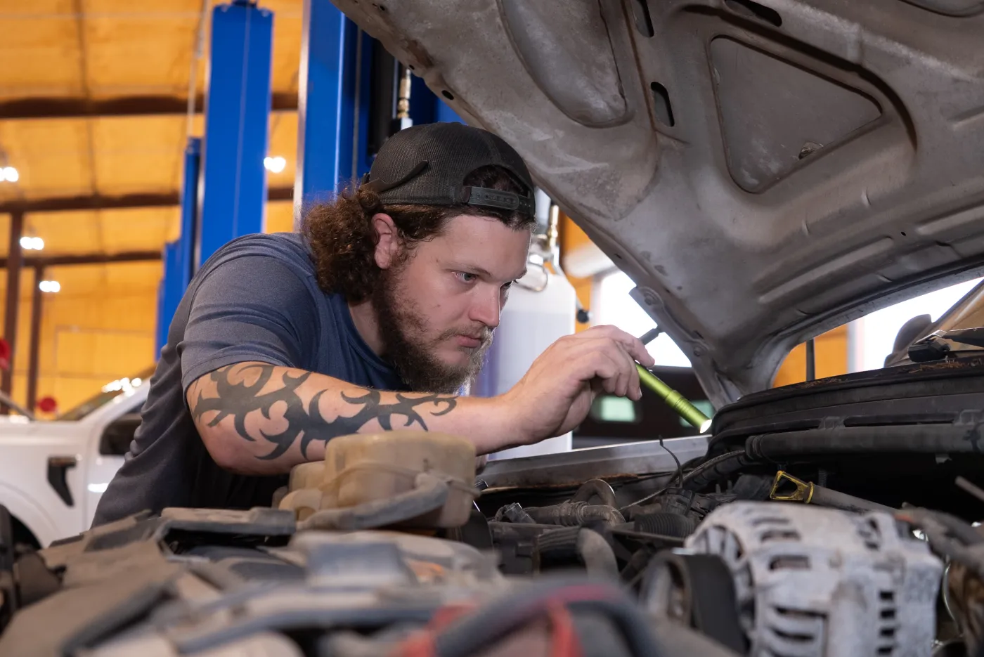Guzman Automotive technician servicing vehicle lights